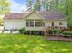 Beautiful backyard featuring lush greenery, a cozy back porch, back deck, and patio set at 1245 Torchlight Way, Raleigh, NC 27603
