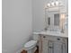 Half bath with a stylish vanity, mirror and light fixture at 1245 Torchlight Way, Raleigh, NC 27603