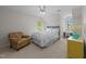 Comfortable bedroom with a ceiling fan, large chair, and desk area at 1245 Torchlight Way, Raleigh, NC 27603