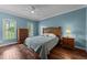 Spacious bedroom with hardwood floors, soft blue paint, and natural light at 1245 Torchlight Way, Raleigh, NC 27603