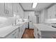Bright kitchen featuring white cabinetry, an island, and hardwood floors at 1245 Torchlight Way, Raleigh, NC 27603