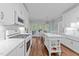 Bright white kitchen with gas range, island, and stainless steel appliances at 1245 Torchlight Way, Raleigh, NC 27603