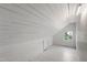 Attic space with hardwood flooring, beadboard paneling and a window at 130 N Bloodworth St, Raleigh, NC 27601