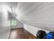 Attic space with hardwood flooring, beadboard paneling and a window at 130 N Bloodworth St, Raleigh, NC 27601