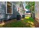 View of the house's exterior with green grass and two AC units in the backyard at 130 N Bloodworth St, Raleigh, NC 27601