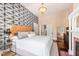 Bright bedroom features unique wallpaper, chandelier, and a fireplace, enhancing the home's character at 130 N Bloodworth St, Raleigh, NC 27601