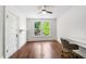 Bedroom with a ceiling fan, hardwood floors, and a desk at 130 N Bloodworth St, Raleigh, NC 27601