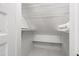 A tidy, all-white closet features neat shelves, beadboard walls and space to store and organize belongings at 130 N Bloodworth St, Raleigh, NC 27601