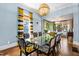 Elegant dining room showcasing a glass table, stylish seating, modern light fixture and ample natural light at 130 N Bloodworth St, Raleigh, NC 27601