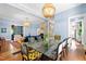 Stylish dining area with hardwood floors, a glass table, and seamless access to the connected living space at 130 N Bloodworth St, Raleigh, NC 27601