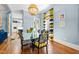 Bright dining room with modern lighting, hardwood floors, and large windows that fill the space with light at 130 N Bloodworth St, Raleigh, NC 27601