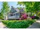 Charming house with covered porches, surrounded by lush greenery and colorful flowers at 130 N Bloodworth St, Raleigh, NC 27601