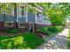 Landscaped front of the house with a path leading to a brick and siding basement entrance at 130 N Bloodworth St, Raleigh, NC 27601