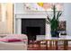 Fireplace featuring a decorative mantel, gas logs, and attractive hardwood flooring at 130 N Bloodworth St, Raleigh, NC 27601