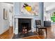 Living room fireplace, marble surround and hearth, with view into the kitchen at 130 N Bloodworth St, Raleigh, NC 27601