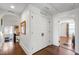 Upstairs hallway with hardwood floors, storage closet, and arched doorway leading to bedroom at 130 N Bloodworth St, Raleigh, NC 27601