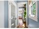 Hallway that leads to a well-lit kitchen, complemented by natural light streaming through the window at 130 N Bloodworth St, Raleigh, NC 27601