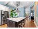 Bright eat-in kitchen featuring stainless steel refrigerator, island with counter seating, and modern finishes at 130 N Bloodworth St, Raleigh, NC 27601