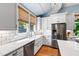 Charming kitchen featuring white cabinetry, subway tile backsplash, and stainless steel appliances at 130 N Bloodworth St, Raleigh, NC 27601
