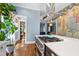 Gourmet kitchen boasts a stainless steel range, quartz countertops, and designer hood, blending style and functionality at 130 N Bloodworth St, Raleigh, NC 27601