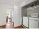 Bright laundry room with washer and dryer featuring a storage shelf with supplies at 130 N Bloodworth St, Raleigh, NC 27601