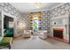 Stylish living room with patterned wallpaper, fireplace, and plush seating; bright and inviting at 130 N Bloodworth St, Raleigh, NC 27601