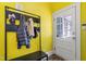 A vibrant mudroom features a convenient coat rack and bench for easy storage and organization near the door at 130 N Bloodworth St, Raleigh, NC 27601