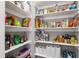 Pantry complete with shelving stocked with a variety of food items and household goods at 130 N Bloodworth St, Raleigh, NC 27601