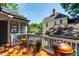 Outdoor seating and grill on a wooden porch with a view of a neighboring house at 130 N Bloodworth St, Raleigh, NC 27601
