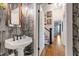 Chic powder room with unique wallpaper, designer mirror and fixtures at 130 N Bloodworth St, Raleigh, NC 27601