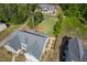 Aerial view of a beautifully landscaped backyard with a garden, lawn, playground, and mature trees, enhancing outdoor living at 1427 Bungalow Ave, Durham, NC 27703