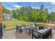 Back patio seating area with comfortable furniture set, patio and views of the spacious, fenced backyard at 1427 Bungalow Ave, Durham, NC 27703