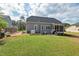 Spacious backyard with patio seating, a well-manicured lawn, and ample space for outdoor activities and entertaining at 1427 Bungalow Ave, Durham, NC 27703