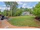 Spacious backyard with play set, patio and lots of green grass at 1427 Bungalow Ave, Durham, NC 27703