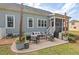Backyard patio with grill and seating with bistro lights and view of the house at 1427 Bungalow Ave, Durham, NC 27703