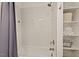 Tiled shower and storage shelves in a clean, contemporary style bathroom with ample natural light at 1427 Bungalow Ave, Durham, NC 27703