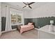 Bright bedroom with a ceiling fan and a large window with natural light and neutral carpet at 1427 Bungalow Ave, Durham, NC 27703