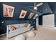 Upper level bonus room features a cozy sofa, exercise bike, and bright decor for versatile living at 1427 Bungalow Ave, Durham, NC 27703