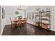 Elegant dining room with dark hardwood floors, large windows, and stylish shelving at 1427 Bungalow Ave, Durham, NC 27703
