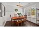 Well-lit dining area with a wooden table, comfortable seating, and bright natural light at 1427 Bungalow Ave, Durham, NC 27703