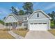 Inviting exterior view of a home with a cozy front porch, lush landscaping, and an attached garage at 1427 Bungalow Ave, Durham, NC 27703
