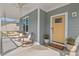 Relaxing front porch with rocking chairs, porch swing, and a vibrant yellow front door at 1427 Bungalow Ave, Durham, NC 27703