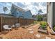 Backyard garden space featuring raised garden beds, crushed stone ground cover and seating area at 1427 Bungalow Ave, Durham, NC 27703