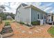 A charming garden area with raised beds and stone pathways, perfect for growing vegetables, herbs, and flowers at 1427 Bungalow Ave, Durham, NC 27703