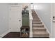 Hallway with stairs and convenient storage bench at 1427 Bungalow Ave, Durham, NC 27703