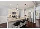 Modern kitchen featuring a granite island with breakfast bar, stainless steel appliances, and white cabinets at 1427 Bungalow Ave, Durham, NC 27703