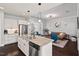 Open concept kitchen featuring an island, stainless steel appliances, and seamless flow to the living room at 1427 Bungalow Ave, Durham, NC 27703