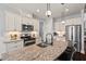 Modern kitchen with granite countertops, stainless steel appliances, and stylish pendant lighting at 1427 Bungalow Ave, Durham, NC 27703