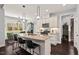 Well-designed kitchen with an island and breakfast bar, stainless appliances, and stylish pendant lighting at 1427 Bungalow Ave, Durham, NC 27703