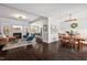 Open-concept living room and dining area with hardwood floors, fireplace, and modern decor at 1427 Bungalow Ave, Durham, NC 27703